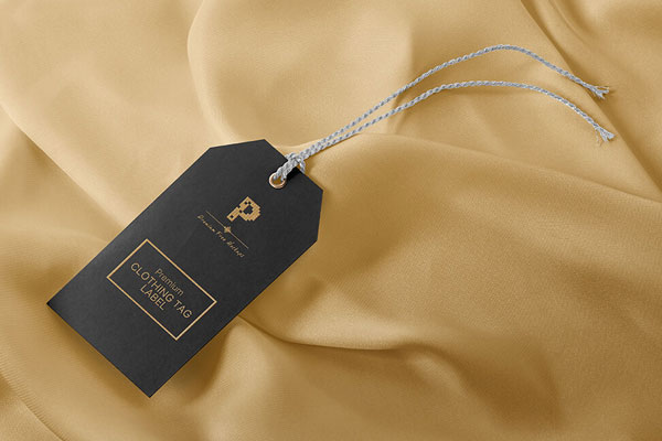 Clothing Tag Label with a String with a Fabric Background Mockup