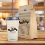 Coffee Cup and Paper Bag on Wooden Texture Mockup