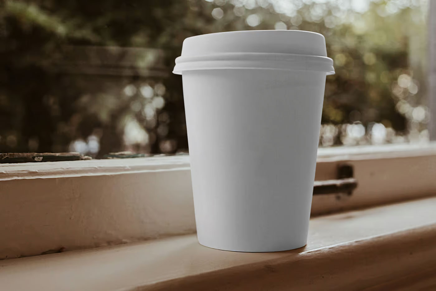 Free Coffee Cup on Window Ledge Mockup PSD Template
