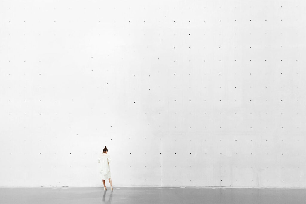 Concrete Wall Mockup Featuring a Woman From Back View