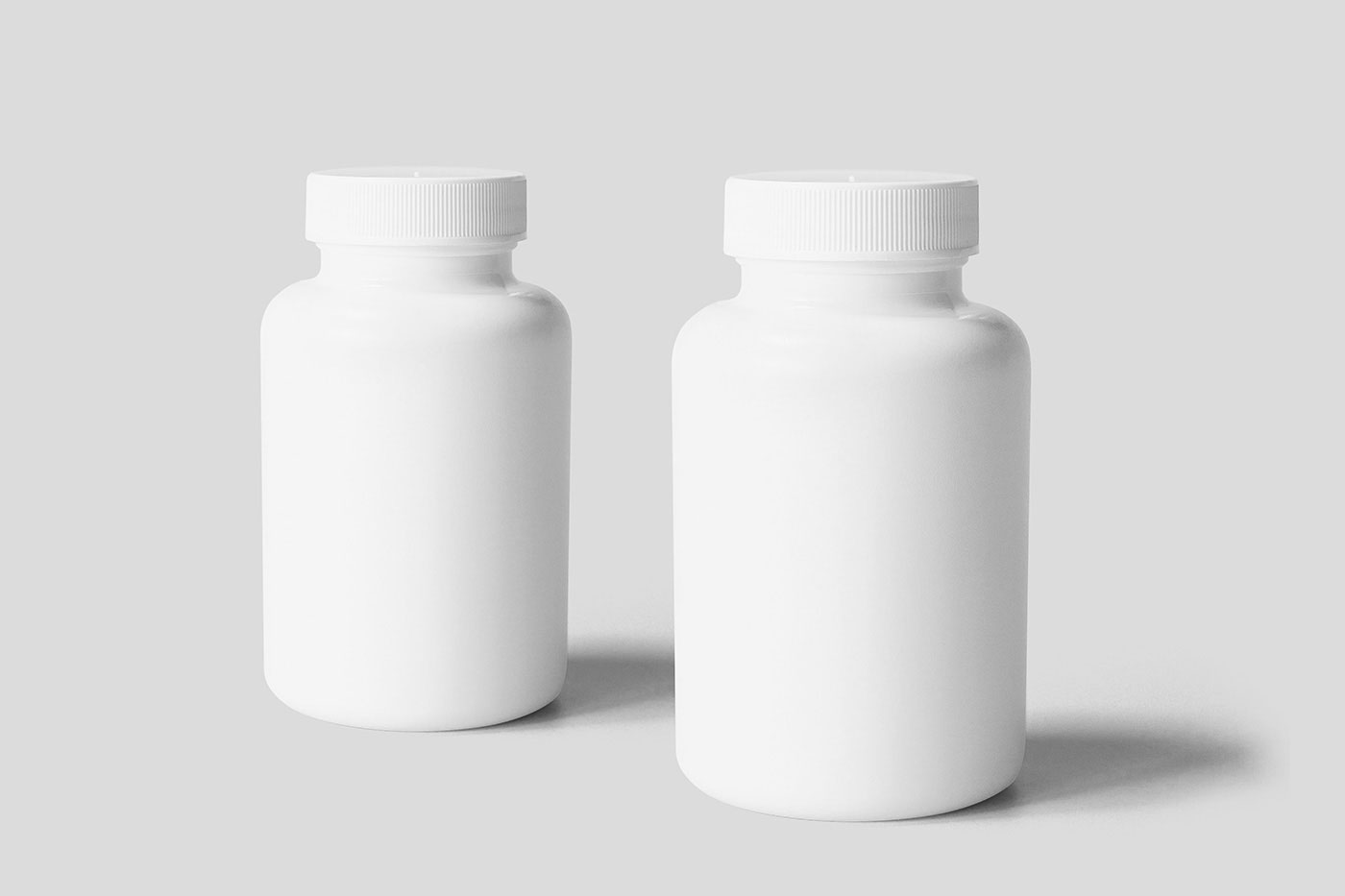 Free Cosmetic Bottle with Cap Mockups PSD Template
