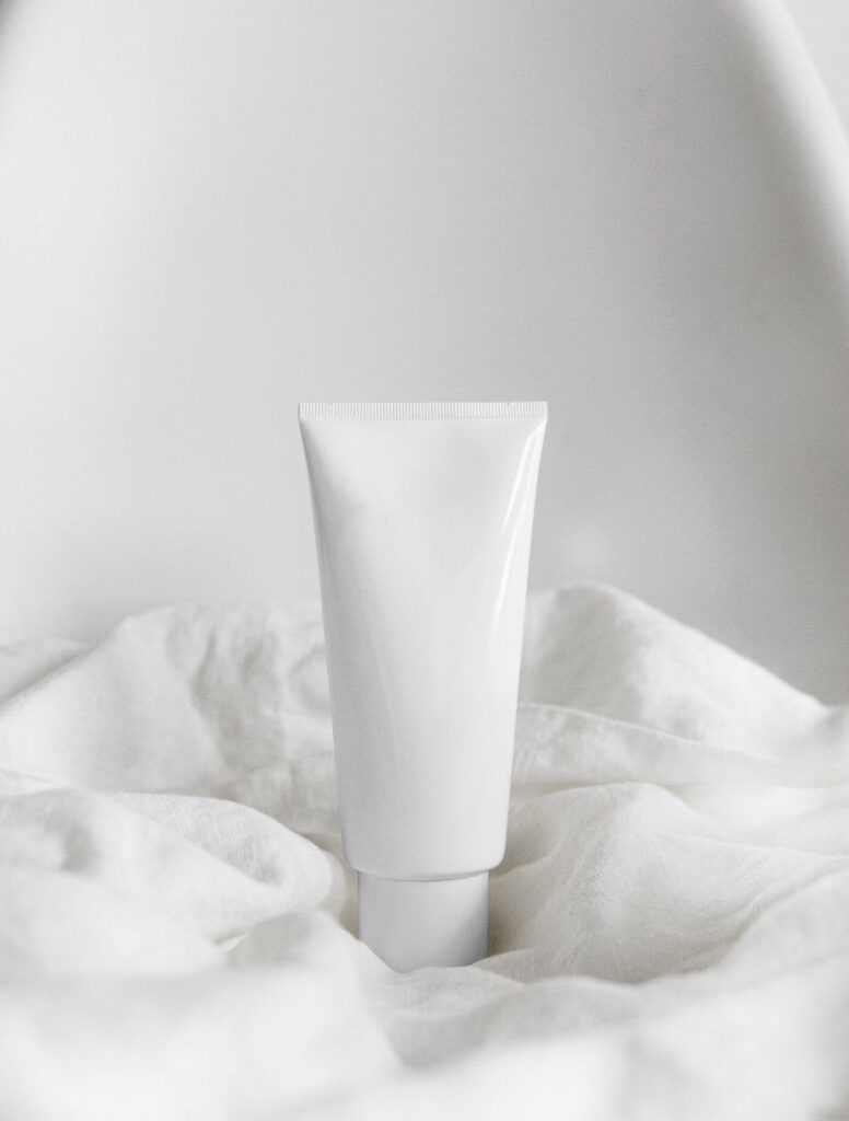 Cosmetics Tube Standing on a Sheets Mockup