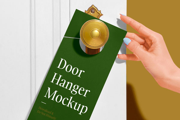 Door Hanger on a Wooden Door Besides a Woman’s Hand Mockup