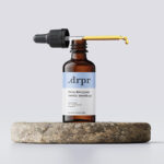 Dropper Bottle and Dropper on a Rock Mockup