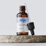 Dropper Bottle and Dropper on a Rock Mockup