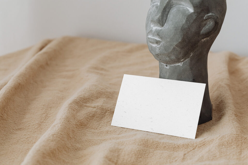 Eco Paper Card Mockup with Statue in Perspective Sight