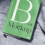 Facing View of Book Cover Mockup on Blanket
