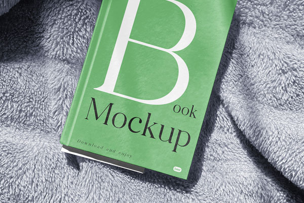 Facing View of Book Cover Mockup on Blanket
