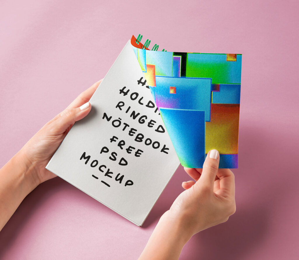 Facing View of Hand Holding Ringed Notebook Mockup