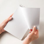 Facing View of Hand Holding Ringed Notebook Mockup