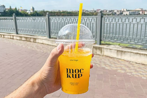 Facing Vision of Plastic Juice Cup Mockup in Hand
