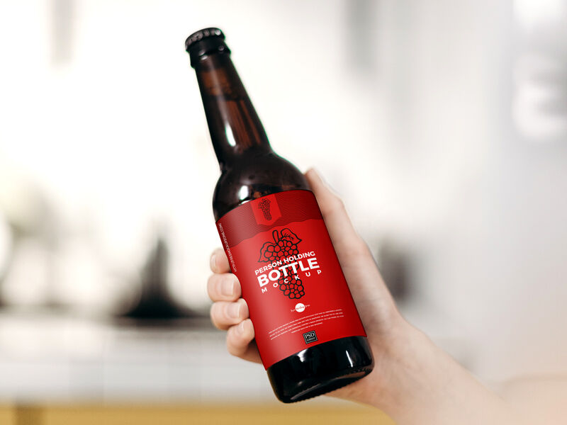 Female Hand Holding Glass Beer Bottle in the Air Mockup