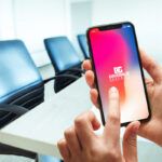 Female Hands Using iPhone X in Conference Room Mockup
