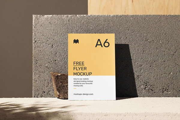 A6 Flyer Mockup in Front of a Concrete Block