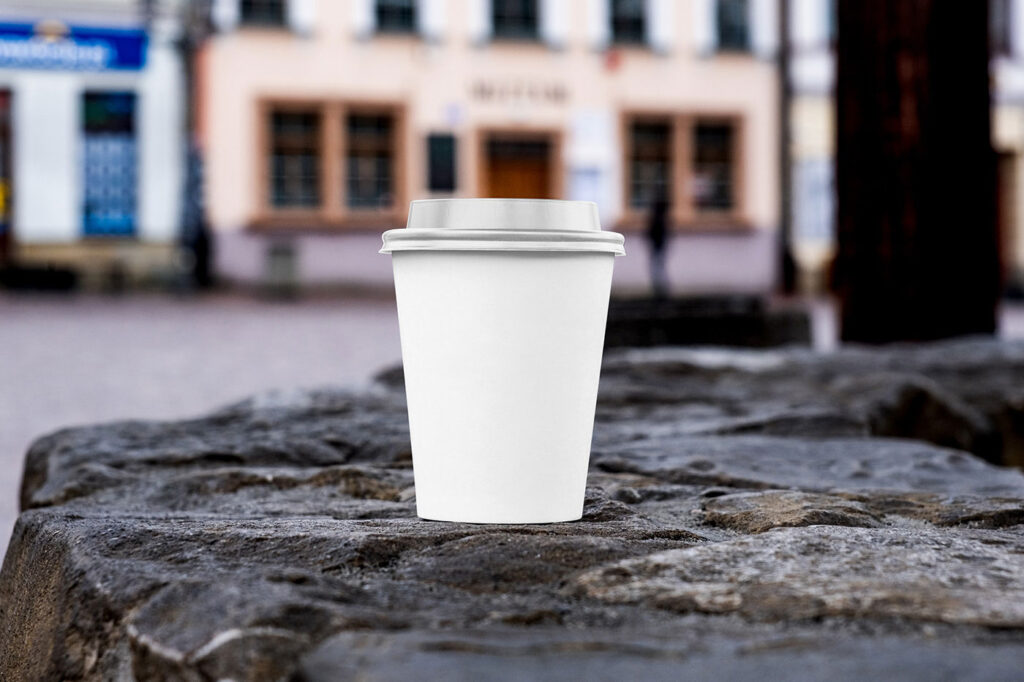 Front Sight of Paper Cup Mockup on Stone Wall