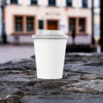 Front Sight of Paper Cup Mockup on Stone Wall