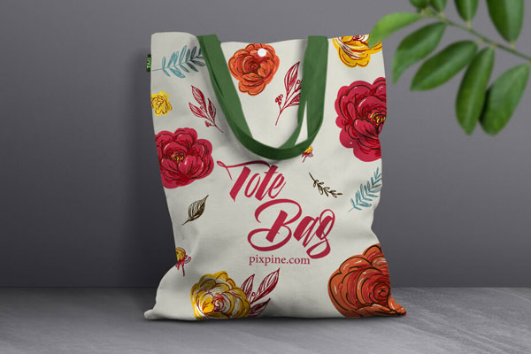 Front View Canvas Bag Leaning Against Wall Mockup with Leaves