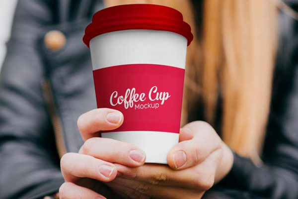 Front View Girl Holding Paper Coffee Cup in Hand Mockup