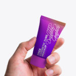Front View Hand Holding Cosmetic Tube Mockup