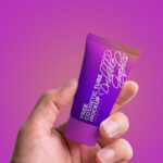 Front View Hand Holding Cosmetic Tube Mockup