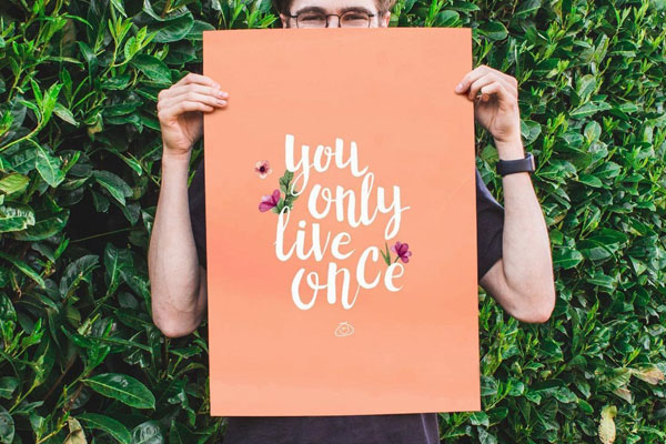 Front View Handhold Poster Mockup in the Middle of Nature