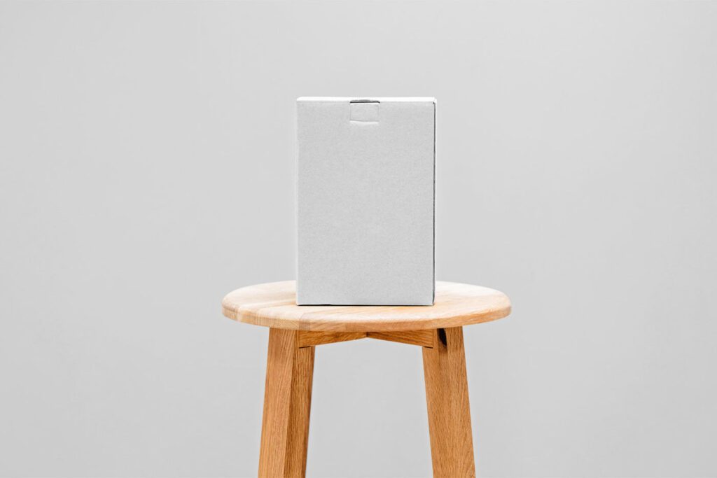 Front View of a Cardboard Box Mockup on a Wooden Chair