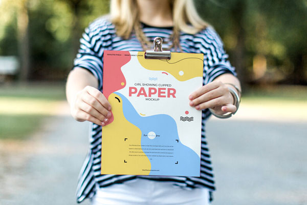 Front View of a Girl Showing Clipped Paper Mockup