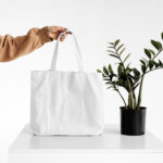 Front View of a Hand Holding Canvas Bag Mockup