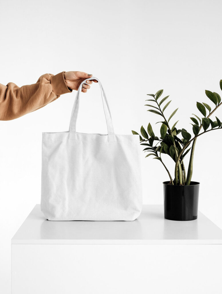 Front View of a Hand Holding Canvas Bag Mockup