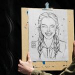 Front View of a Hand Holding Drawing Board Artwork Showcase Mockup