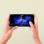 Front View of a Hand-Holding Landscape Smartphone Screen Mockup