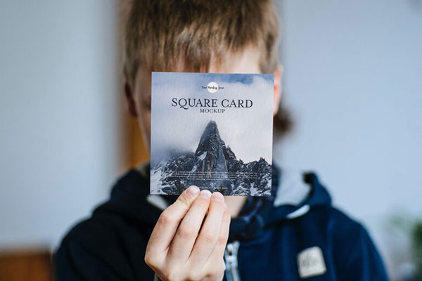 Front View of a Little Boy Showing a Square Card Mockup