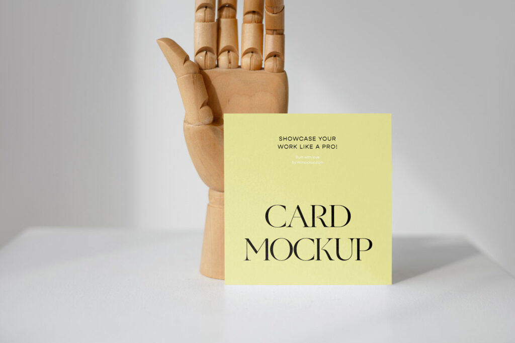 Front View of a Standing Card Mockup with a Wooden Hand