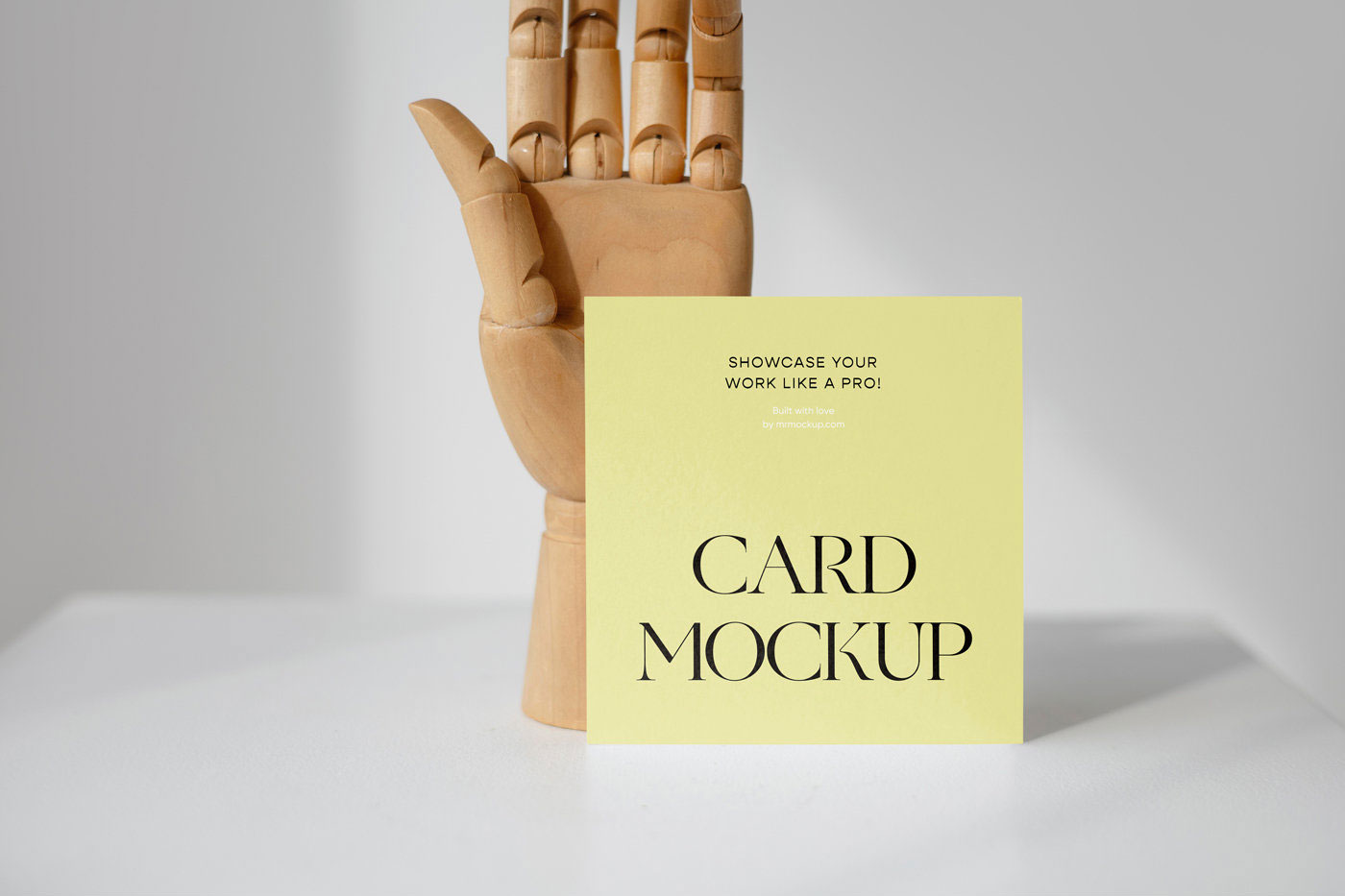 Front View of a Standing Card Mockup with a Wooden Hand FREE PSD