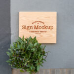 Front View of a Wooden Shop Sign on Wall Mockup