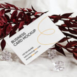 Front View of Business Card Mockup Standing at Angle with Leaf