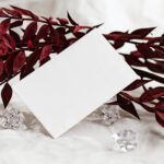 Front View of Business Card Mockup Standing at Angle with Leaf