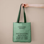 Front View of Canvas Shopping Bag Mockup in Hand