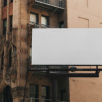 Front View of City Billboard Mockup on Side of Building