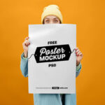 Front View of Female Holding Huge Poster Mockup