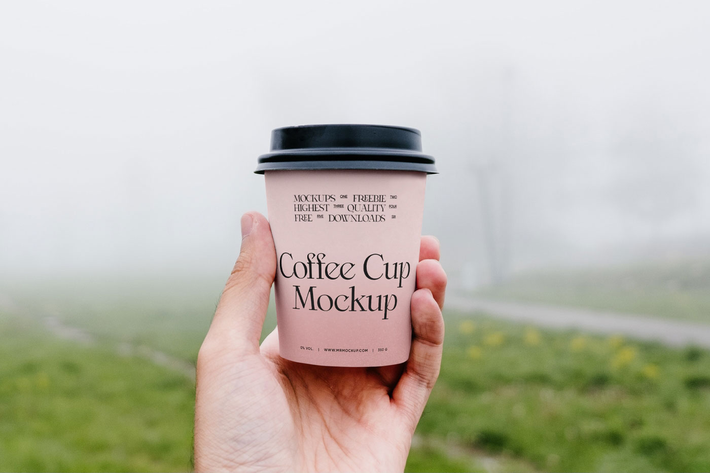 Front View of Hand Holding Coffee Cup Mockup in Park FREE PSD