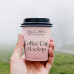 Front View of Hand Holding Coffee Cup Mockup in Park