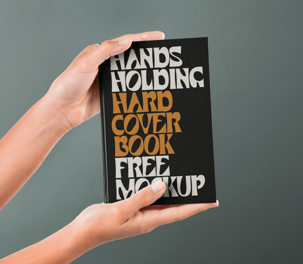 Front View of Hand Holding Hardcover Book Mockup