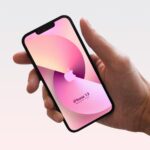Front View of Hand Holding iPhone 13 Mockup