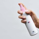 Front View of Hand Holding Lean Spray Bottle Mockup