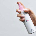 Front View of Hand Holding Lean Spray Bottle Mockup