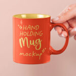 Front View of Hand Holding Mug Mockup