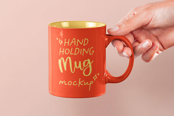 Front View of Hand Holding Mug Mockup