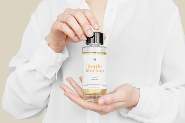 Front View of Hand Holding Plastic Bottle Mockup