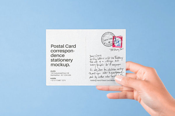 Front View of Hand Holding Postal Card Mockup